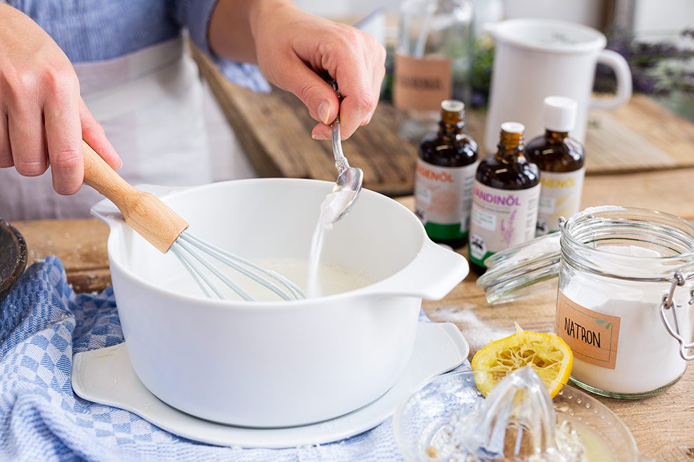 De ingrediënten voor de zelfgemaakte textielverfrisser worden in een kom gemengd.